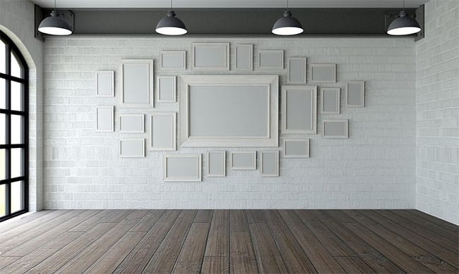 A collection of empty picture frames hung on a wall, creating a unique gallery display.
