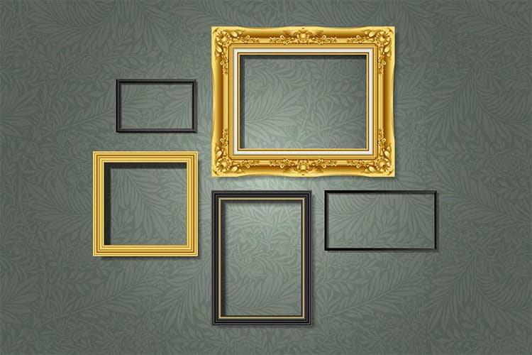 A collection of empty picture frames hanging on a dark wall.